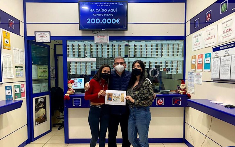 Bárbara, Juan y Beatriz, de la administración de lotería del Centro Comercial H2O, posan con el número agraciado con un cuarto premio en el sorteo de Navidad